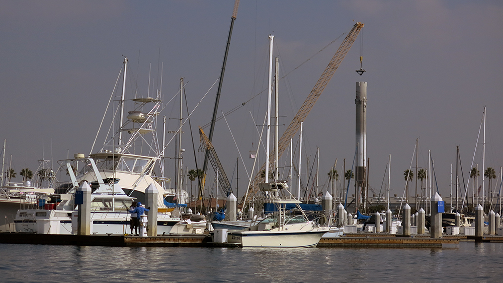 The SpaceX rocket booster hidden amongst the masts in the marina