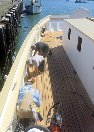Sanding and caulking the deck was hard work in the hot sun