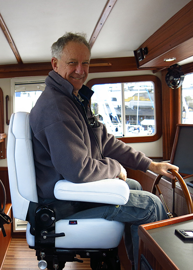 Neil having fun at the helm of a Nordic Tug - really nice boats